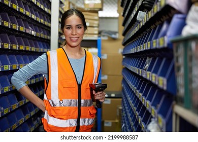 Factory Worker Holding Laser Barcode Scanner In Spare Parts Storage Cabinet