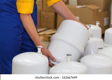 Factory worker holding a pressure vessel ready to be sold