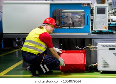 Factory worker maintaining a factory machine