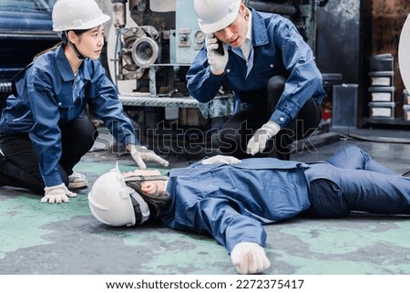 A factory worker making an emergency call at the plant