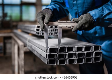 Factory Worker Measures The Metal Profile