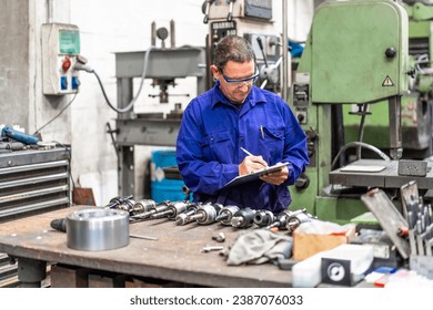 Factory worker operator in the numerical control sector making a report, industrial factory