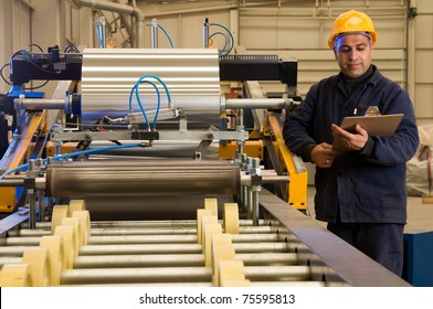 Factory Worker Processing Roll Of Steel Sheet - A Series Of METAL INDUSTRY Images.