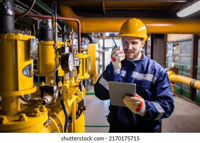 Factory Worker Serviceman Checking Natural Gas Pipeline Installations And Using Tablet Computer.