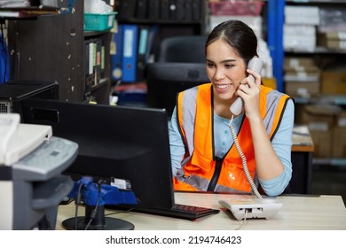 factory worker speaking on the telephone and looking at computer monitor in the office or warehouse storage - Powered by Shutterstock