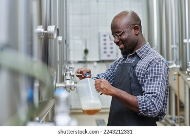 Factory worker tasting brewed beer - Powered by Shutterstock