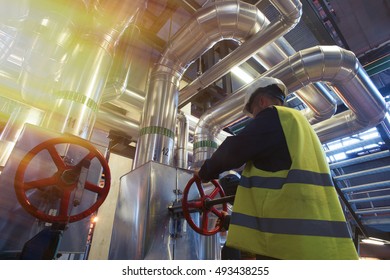 factory worker turning valve