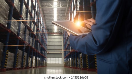 Factory worker using application on smart tablet to operate automation for modern trade. Import and export the shipping cargo of global logistic.
