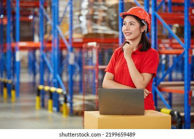 Factory Worker Or Warehouser Smiling With Laptop Computer And Thinking Pose In Warehouse Storage