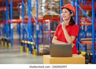 Factory Worker Or Warehouser Smiling With Laptop Computer And Thinking Pose In Warehouse Storage