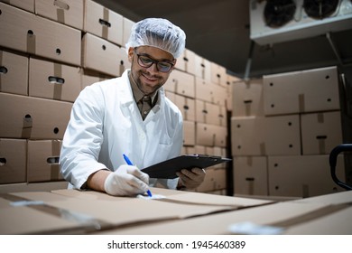 Factory Worker Wearing Hairnet And Hygienic Gloves Preparing Fresh Food Packages For Distribution And Market Sale.