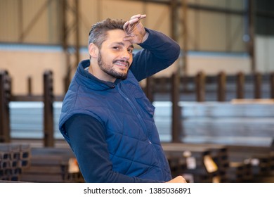 Factory Worker Wiping Sweat From Brow