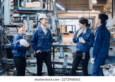 Factory workers chatting amiably during break time - Powered by Shutterstock