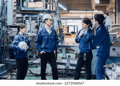 Factory workers chatting amiably during break time - Powered by Shutterstock