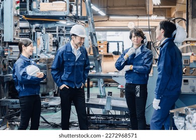 Factory workers chatting amiably during break time - Powered by Shutterstock