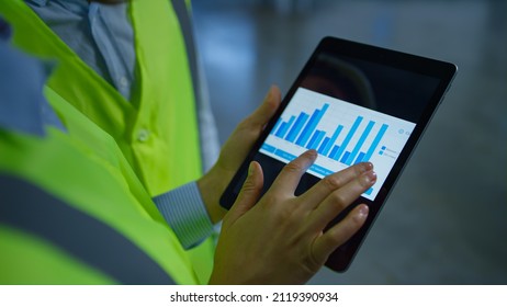 Factory workers checking production data inspection on tablet graphs analysis. Close up technological manufacturing device displaying important statistic info. Tech storehouse job information concept