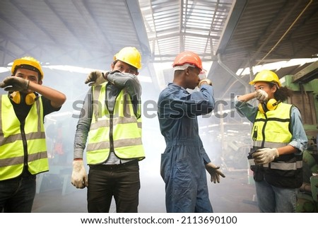 factory workers close the nose because there is a fire and smoke in machine factory