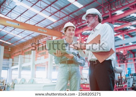 Factory workers or engineer worker working for check and analyze newly arrived goods using laptop and digital tablet, teamwork and synergy concept, vintage tone.