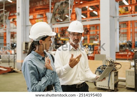 Factory workers or engineer worker working for check and analyze newly arrived goods using laptop and digital tablet, teamwork and synergy concept, Metal sheet automated production factory.