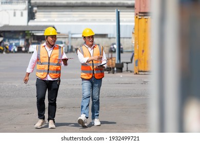 Factory Workers Or Engineers Talking And Exploring Container In Factory Workshop