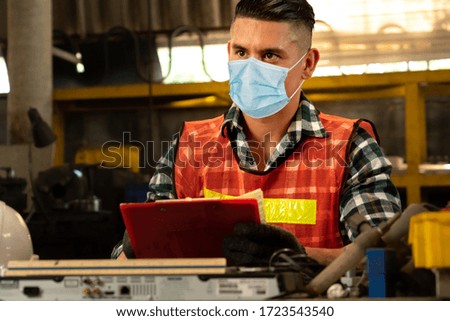 Factory workers with face mask protect from outbreak of Coronavirus Disease 2019 or COVID-19.
