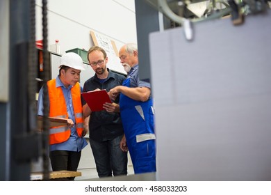 Factory workers with supervisor - Powered by Shutterstock