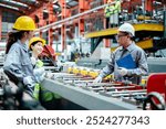 factory workers in uniform together work inspecting operation manufacturing Metal Roofing Sheet Machine in the factory metal sheet, Metalwork roof manufacturing and quality control process.