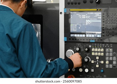 Factory workers using CNC lathe machine