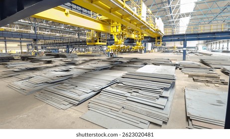 Factory workshop with lifting crane device timelapse hyperlapse, lift loads using lifting magnet, mechanical workshop, metal sheets structures on the floor of plant.