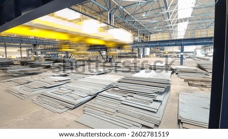 Factory workshop with lifting crane device timelapse hyperlapse, lift loads using lifting magnet, mechanical workshop, metal sheets structures on the floor of plant.