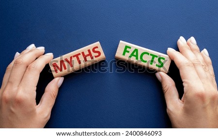Facts or Myths symbol. Concept word Facts or Myths on wooden blocks. Businessman hand. Beautiful deep blue background. Business and Facts or Myths concept. Copy space