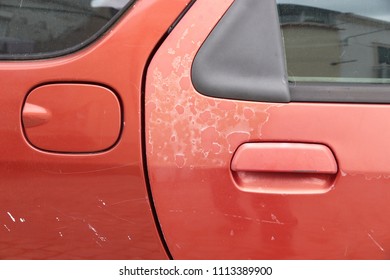 Faded Car Paint - Peeling Paint Surface In A 20 Year Old European Red Car.