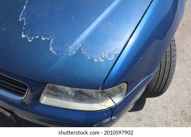 Faded Car Paint - Peeling Paint Surface In A 15 Year Old Compact Blue Car.