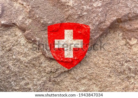 Faded Swiss national emblem symbol, Coat of arms of Switzerland isolated on weathered solid rock wall background, abstract positive design faithful Swiss politics society culture concept texture
