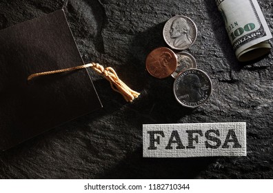 FAFSA (Free Application For Federal Student Aid) Text With Graduation Cap And Money -- Financial Aid Concept                               