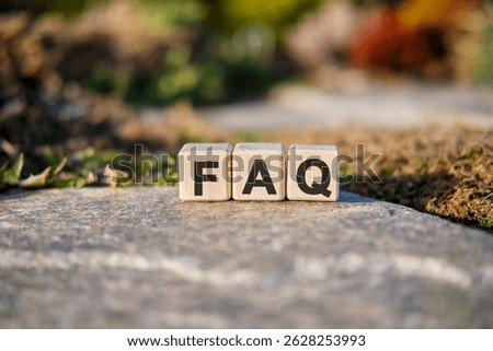 Fag text on cubes standing on a stone on a natural background