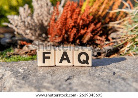 Fag text on cubes standing on a stone on a natural background