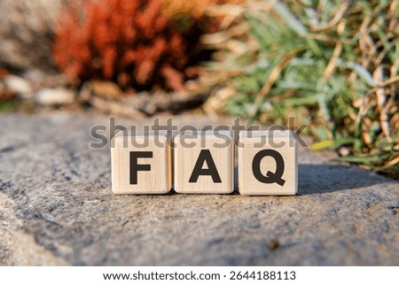 Fag text on cubes standing on a stone on a natural background