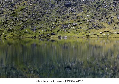Fagaras mountains mirrored in Balea alpine glacial lake
