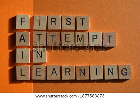 Fail, acronym for First Attempt in Learning, in wooden alphabet letters isolated on orange background