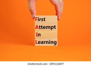 FAIL first attempt in learning symbol. Wooden blocks with words FAIL first attempt in learning. Beautiful orange table, orange background, copy space. Business, FAIL first attempt in learning concept.