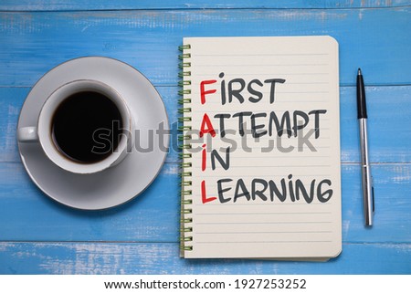 Fail first attempt in learning, text words typography written on paper against wooden background, life and business motivational inspirational concept
