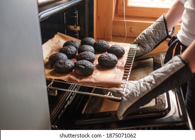 Failed Cooking In Oven. Woman Holding A Tray Of Spoiled Muffins