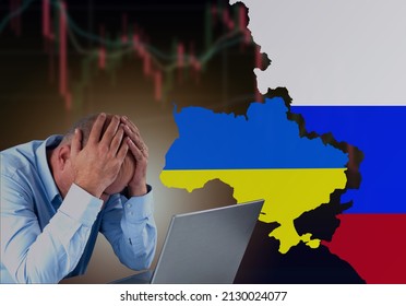 A failed investor sitting sad in front of laptop with Ukraine and Russia flag with stock market chart turn red and going down. Economic crisis because of the war concept.