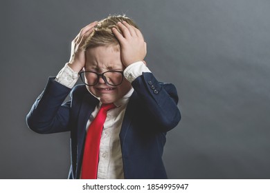 Failed Kid Boy With Hands On Head. Shocked, Surprised Child Fed Up, Bored Or Showing Despair Child Businessman Cry. Back To School.