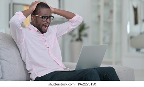 Failure, African Man having Loss on Laptop at Home 