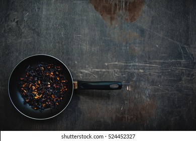 The Failure On Kitchen: Burnt Charred Vegetables. Frying Pan With Refried Black Onion And Overcooked Orange Carrots. Cooking Fail Concept Background With Copy Space.