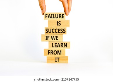 Failure or success symbol. Wooden blocks with words Failure is success if we learn from it. Beautiful white background, copy space. Businessman hand. Business, learn from failure or success concept.