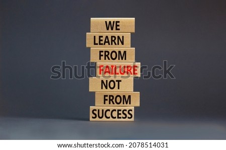 Failure or success symbol. Wooden blocks with words We learn from failure not from success. Beautiful grey background, copy space. Business, learn from failure or success concept.