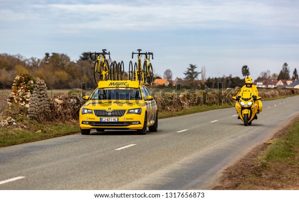 Fains-la-Folie, France - March 5, 2018: The yellow\
technical car and bike of  Mavic driving on a country road during\
the stage 2 of Paris-Nice\
2018.